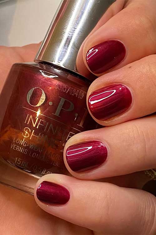 Short burgundy pearl nails using OPI Big Sagittarius Energy from OPI Big Zodiac Energy Collection 2023