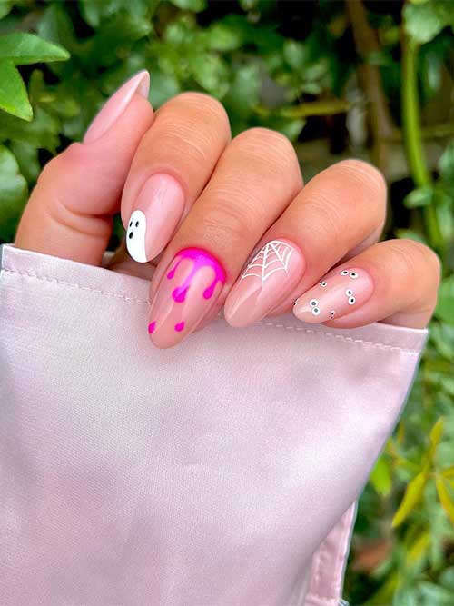 Short nude Halloween nails with simple Halloween nail art designs feature pink drips, a spiderweb, and ghost eyes.