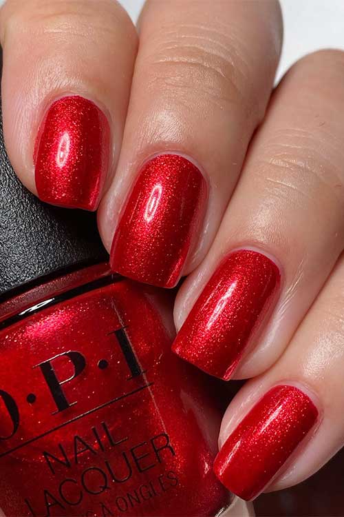 Short shimmer fiery red nails using OPI Kiss My Aries from OPI Big Zodiac Energy Collection 2023