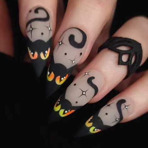 Spooky matte Black Halloween French tip nails with cat eyes and stars Halloween nail art designs