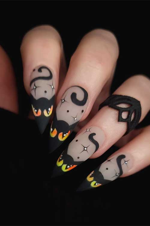 Spooky matte Black Halloween French tip nails with cat eyes and stars Halloween nail art designs