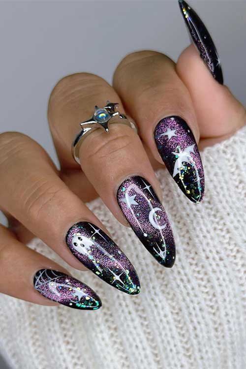 Spooky shimmer black and purple cat eye nails with white celestial nail art, ghosts, and cobwebs. 