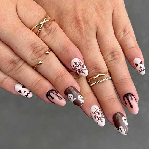 Spooky white, nude, and dark brown Halloween nail art design.