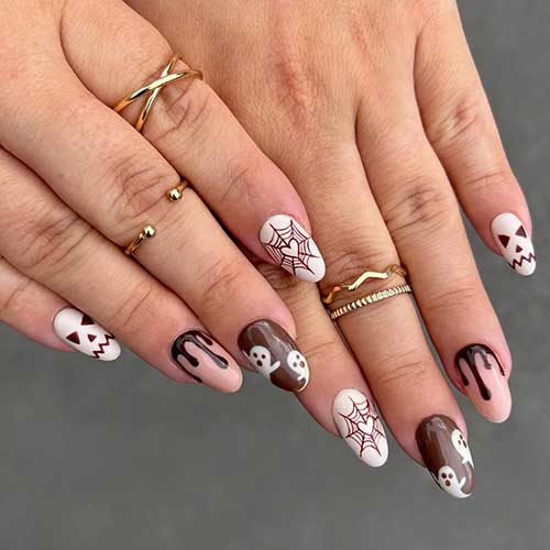 Spooky white, nude, and dark brown Halloween nail art design. Spooky white, nude, and dark brown Halloween nail art design.