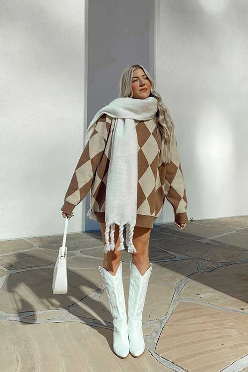 Stylish oversized sweater with tall boots and chunky scarf