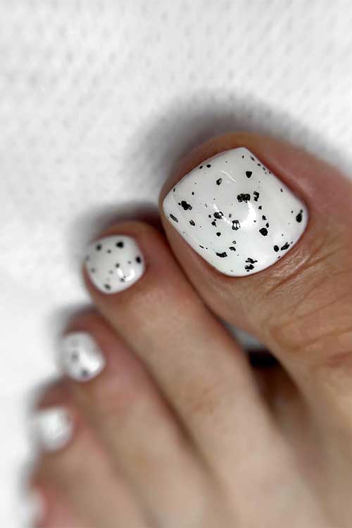 White gel toe nails with black speckles