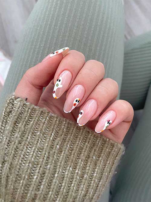 White ghost French tip nails with autumnal-colored flowers.