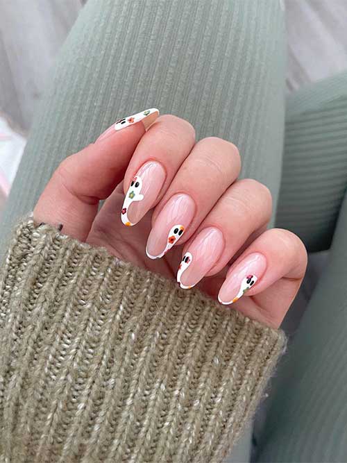 White ghost French tip nails with autumnal-colored flowers. White ghost French tip nails with autumnal-colored flowers.