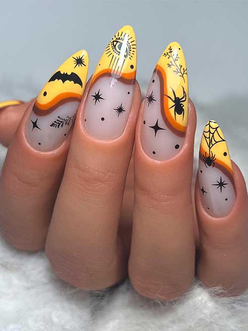 Yellow French tip Halloween nails with burnt orange and brown swirl nail art, cobwebs, spiders, bats, and celestial nail art on the tips.