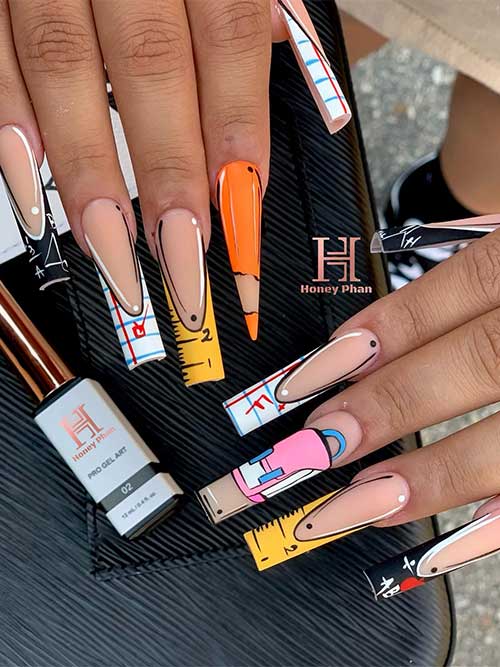 long French tips with various back-to-school nail art and a stiletto pencil accent nail