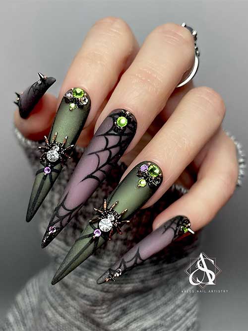 long stiletto green and black Halloween nail art design features cobwebs and is adorned with 3D spiders and rhinestones.