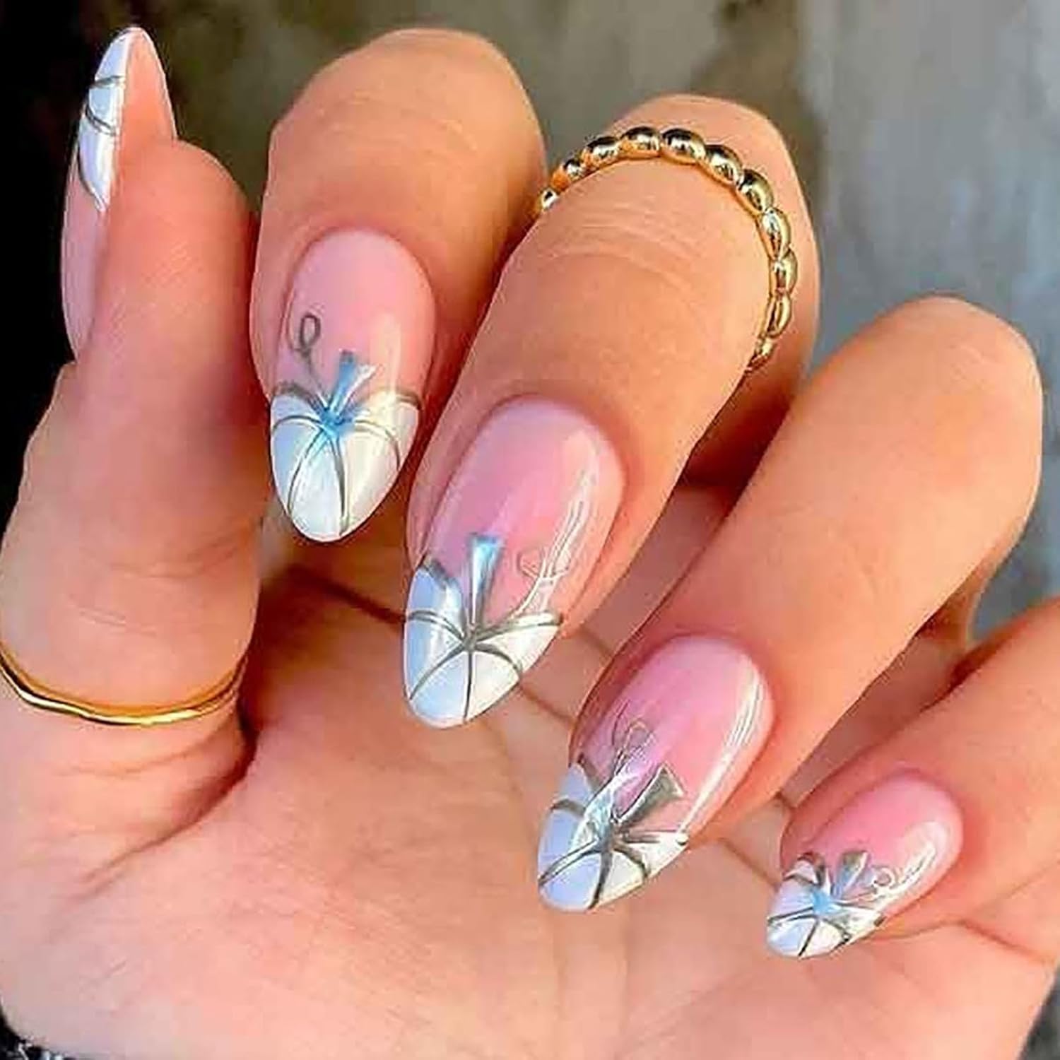 Medium almond-shaped pink French tip press-on nails with white pumpkin and silver line designs, glossy finish, 24 pieces. Medium almond-shaped pink French tip press-on nails with white pumpkin and silver line designs, glossy finish, 24 pieces.
