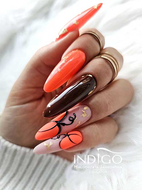 A long fall pumpkin nail design features two orange nails, two nude pink nails with matte orange pumpkins