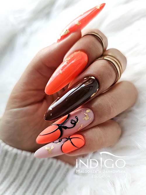 A long fall pumpkin nail design features two orange nails, two nude pink nails with matte orange pumpkins A long fall pumpkin nail design features two orange nails, two nude pink nails with matte orange pumpkins