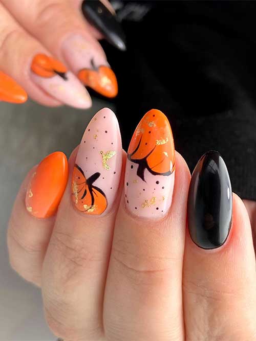 Black and orange fall pumpkin nails with gold flakes Black and orange fall pumpkin nails with gold flakes