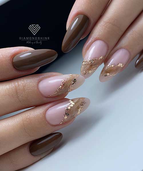 Brown nails with a creative marble nail art adorned with gold glitter on a little area on two accent nude pink nails