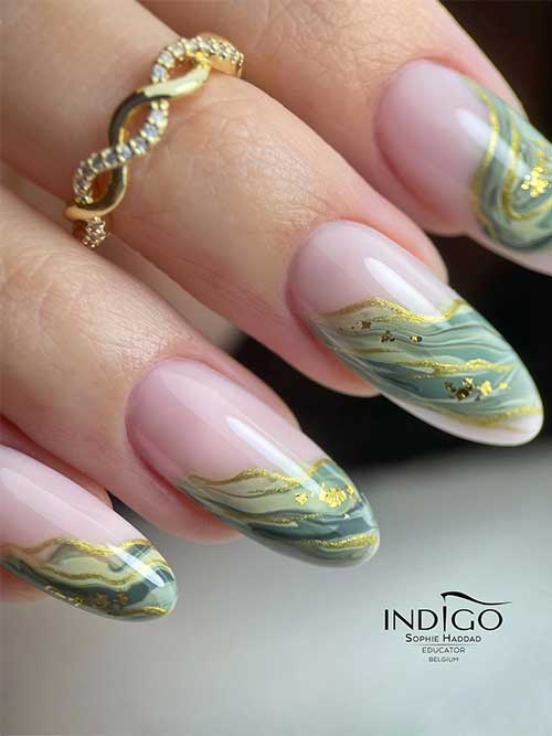 Classy French manicure with a twist that uses green marble nail art adorned with gold polish and gold flakes