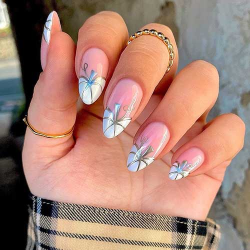 Medium almond shaped French white pumpkin nails with gold outlines and leaf nail art