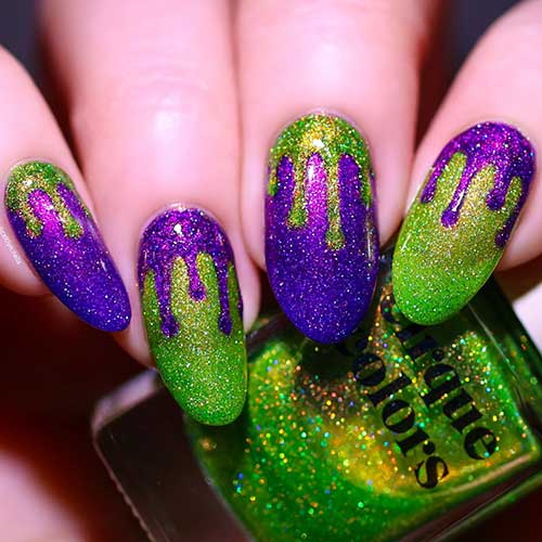 Glittery green and purple Halloween nail design with drip nail art alternatively. Glittery green and purple Halloween nail design with drip nail art alternatively.