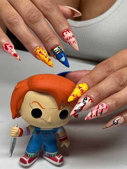 Long Chucky Nails feature Chucky clothes on an accent nail and blood nail art, a knife, and words such as “wanna play”
