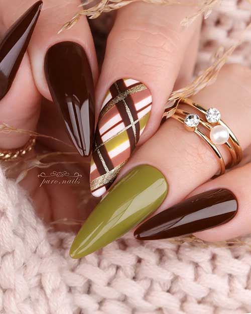 Long almond dark brown fall nails with an accent light olive green nail and crisscross nail art on the middle fingernail