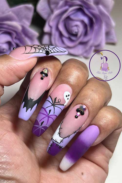 Long matte coffin purple Halloween nails with different purple hues and the design features pumpkins, a cobweb, and a bat Long matte coffin purple Halloween nails with different purple hues and the design features pumpkins, a cobweb, and a bat