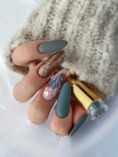 Matte fall green nails with a gold glitter accent nail and a nude accent nail adorned with white leaf and abstract nail art