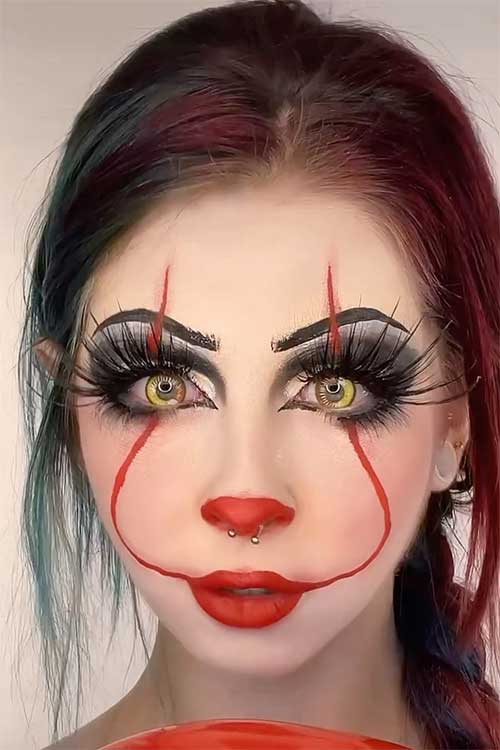 Scary Pennywise Makeup with very long lashes and yellow eye contacts is one of the best Halloween makeup looks scary