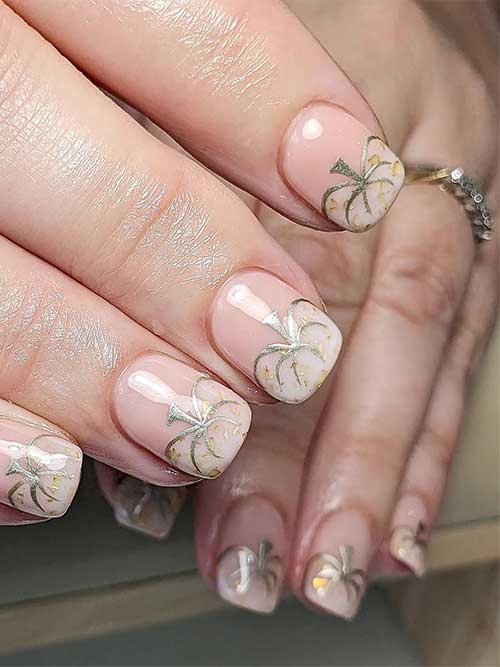 Short nude nails with a ghost pumpkin on each nail tip adorned with chrome gold outlines and gold glitter Short nude nails with a ghost pumpkin on each nail tip adorned with chrome gold outlines and gold glitter