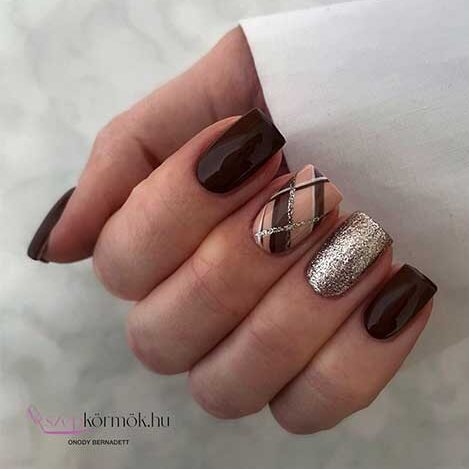 Short square-shaped chocolate brown fall nails with an accent gold glitter nail and another crisscross accent nail