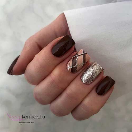 Short square-shaped chocolate brown fall nails with an accent gold glitter nail and another crisscross accent nail