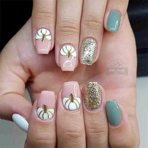 White and sage green manicure adorned with a gold glitter accent nail and two accent white pumpkin nails