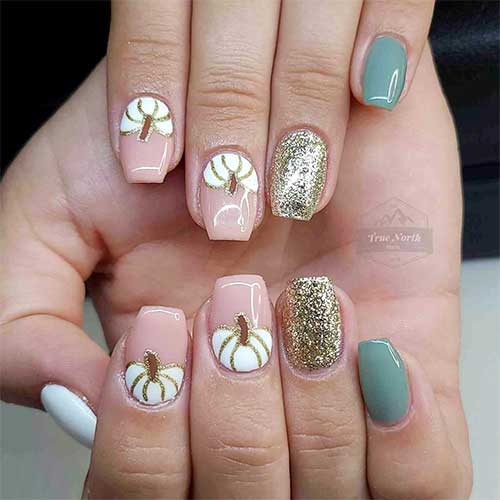 White and sage green manicure adorned with a gold glitter accent nail and two accent white pumpkin nails White and sage green manicure adorned with a gold glitter accent nail and two accent white pumpkin nails
