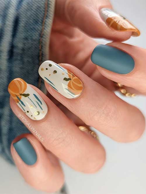 White nails with burnt orange pumpkin nails adorned with gold patches besides, two accent matte olive nails