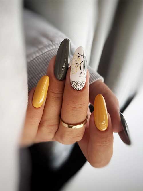 Yellow and olive fall green nails with abstract nail art on an accent milky white nail