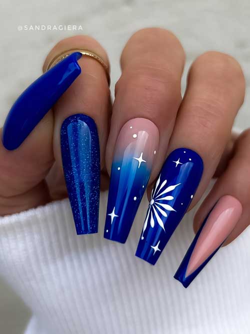 Coffin navy blue Christmas nails with a glittery nail, an ombre nail with white stars, and a big white snowflake on accent