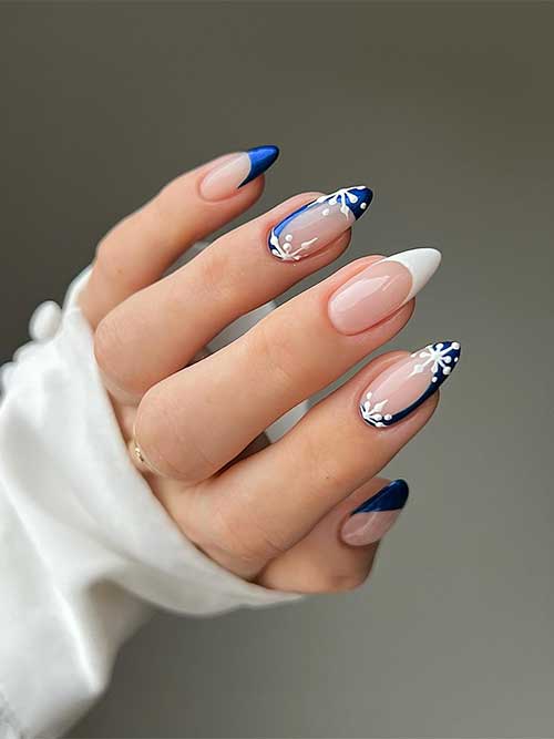 Glossy French navy blue Christmas nails with white snowflakes on two accent nails, and a white French middle accent nail