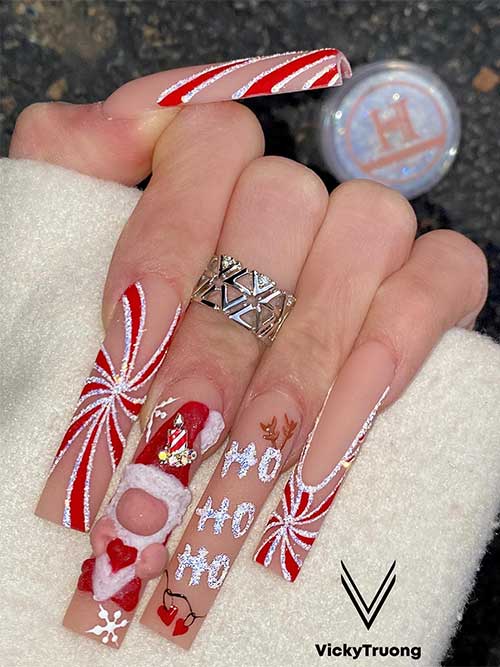 Long Christmas nails feature red and silver glitter candy cane designs, Santa Clause with snowflakes on an accent nail