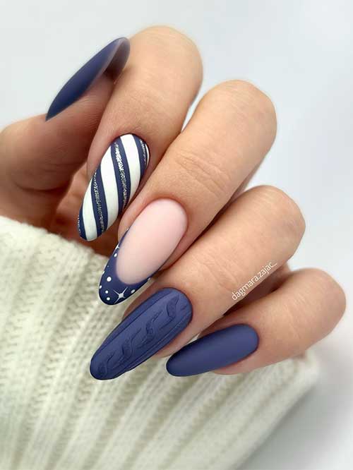 Long Matte navy blue Christmas nails with sweater nail art, a French tip with tiny white stars, and a candy cane accent
