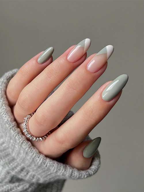 Long almond sage green nails with two white and sage green French tip accent nails.