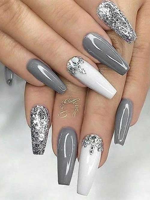 Long coffin gray nails with an accent white nail adorned with silver rhinestones. Besides, a silver glitter accent nail