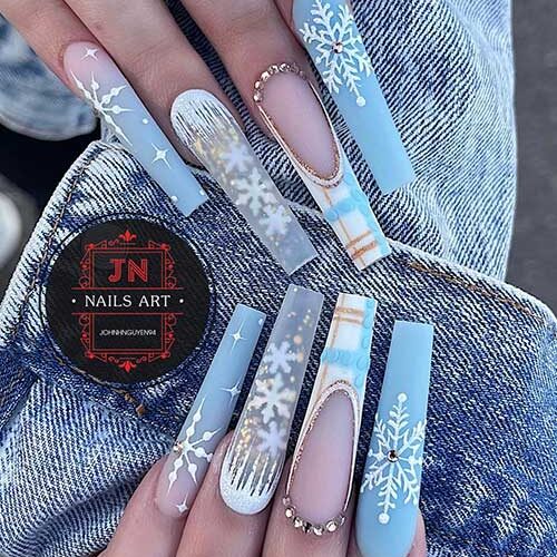 Long coffin matte ice blue winter nails 2023 with white snowflakes adorned with gold rhinestones