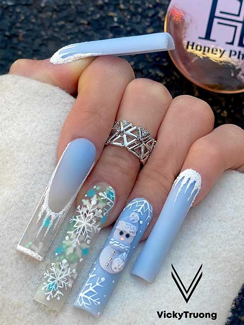 Long icy blue Christmas nails with icicle nail art, a snowman, and a glitter accent nail adorned with snowflakes