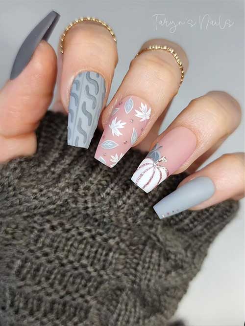 Matte coffin light gray nail idea features a sweater accent nail and a nude accent nail adorned with gray and white leaves