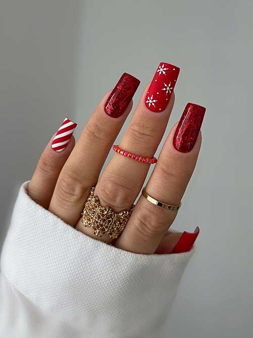 Red Christmas Nails 2023 features two matte red nails with snowflakes and an accent white and red candy cane nail.