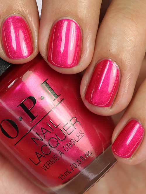 Shimmery fuschia nails using OPI Blame the Mistletoe nail polish from OPI Terribly Nice Holiday 2023 Collection