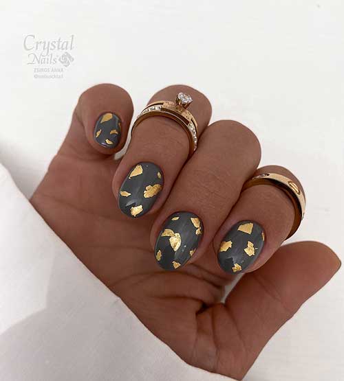 Short grey nails with gold flakes are one of the cutest grey nail ideas.