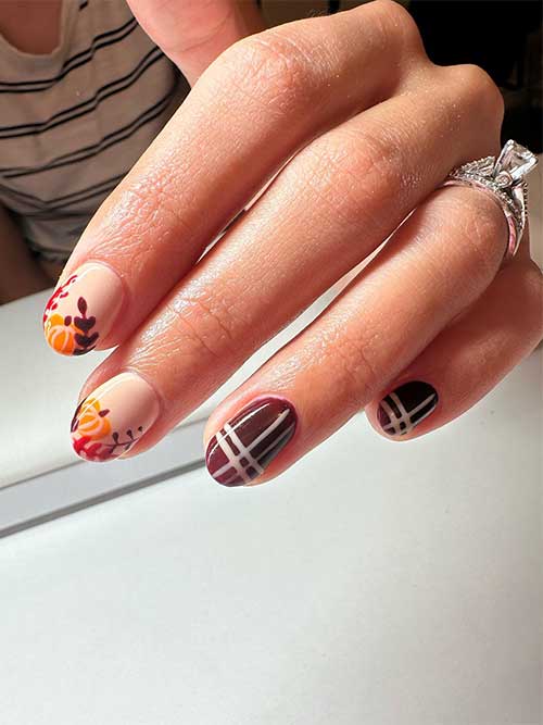 Short nude and brown Thanksgiving nail design features fall leaves and pumpkins on two nude accent nails and two brown nails