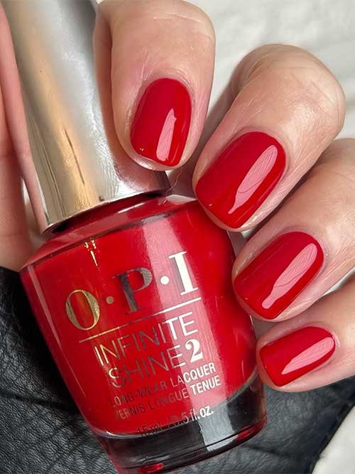 Short red nails using OPI Rebel With A Clause nail polish from OPI Terribly Nice Holiday 2023 Collection