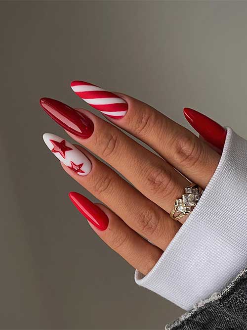  Simple gel red Christmas nails with a candy cane accent nail and a white nail adorned with red stars.